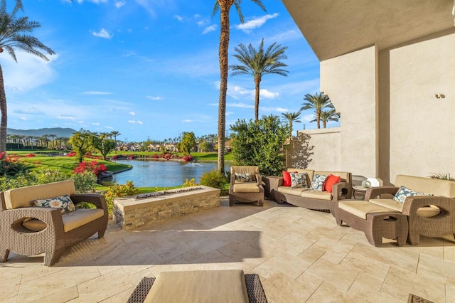 view of patio / terrace with an outdoor living space and a water and mountain view