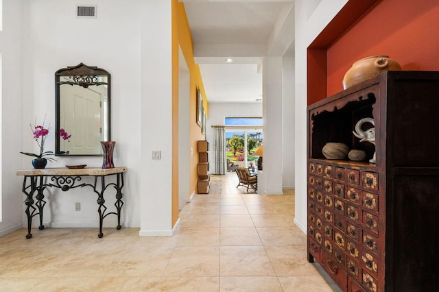 corridor with light tile patterned floors