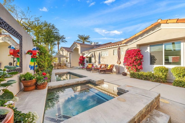 view of pool with an outdoor hangout area, a patio, and an in ground hot tub