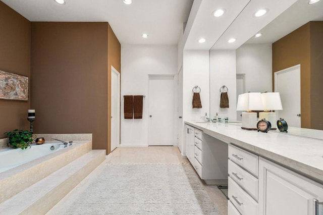 bathroom featuring a washtub and vanity