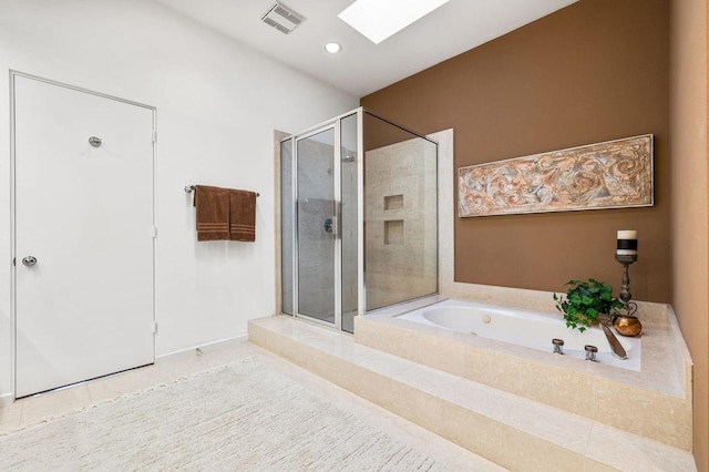 bathroom featuring a skylight, shower with separate bathtub, and tile patterned flooring