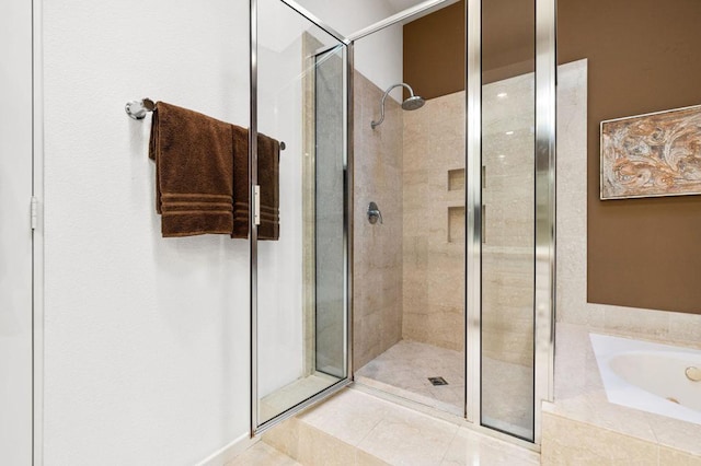 bathroom with separate shower and tub and tile patterned flooring