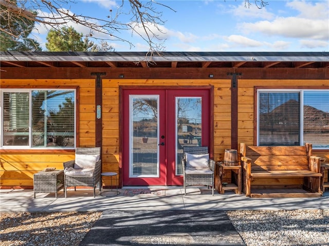 view of exterior entry featuring french doors and a patio