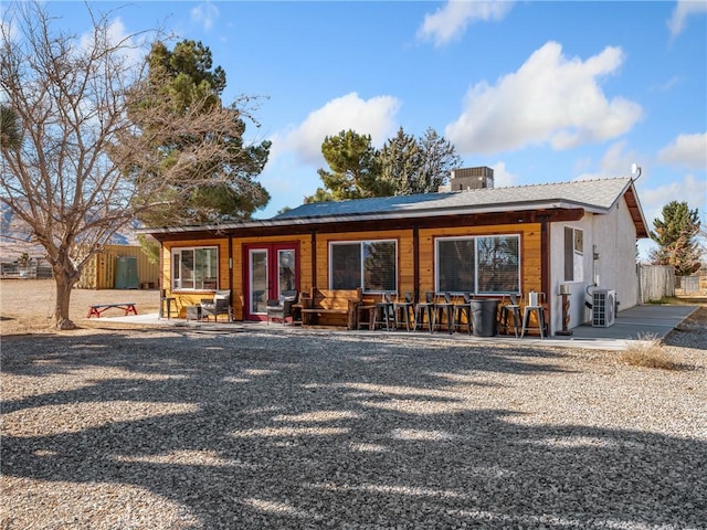 single story home with ac unit and a patio