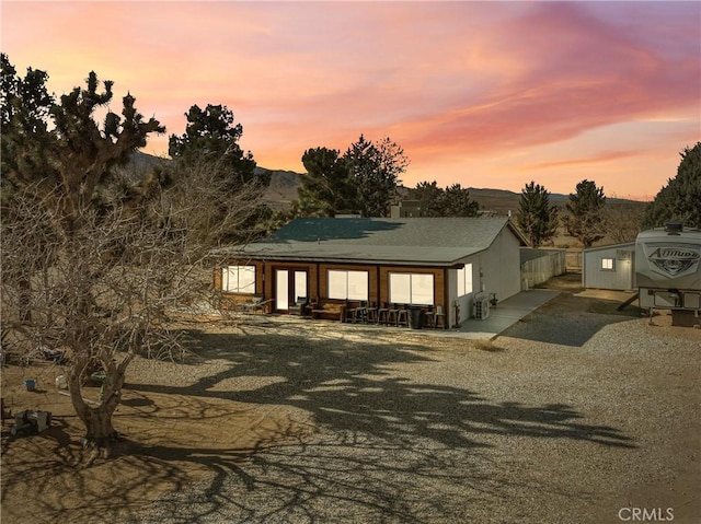 view of front facade with a patio area and a mountain view