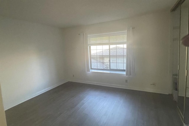 spare room featuring dark hardwood / wood-style flooring