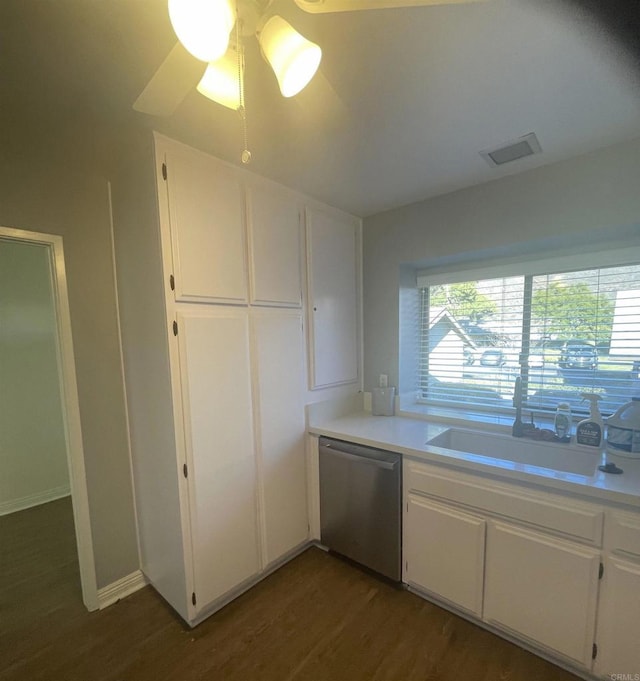 kitchen with white cabinetry, sink, stainless steel dishwasher, and dark hardwood / wood-style flooring