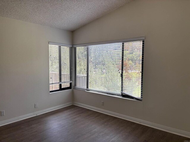 4115 Cyprus Island Ct, Fallbrook, CA 92028 - unfurnished room featuring a textured ceiling, dark wood-style floors, vaulted ceiling, and baseboards