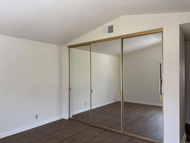 4115 Cyprus Island Ct, Fallbrook, CA 92028 - unfurnished bedroom featuring vaulted ceiling, wood finished floors, a textured ceiling, a closet, and baseboards
