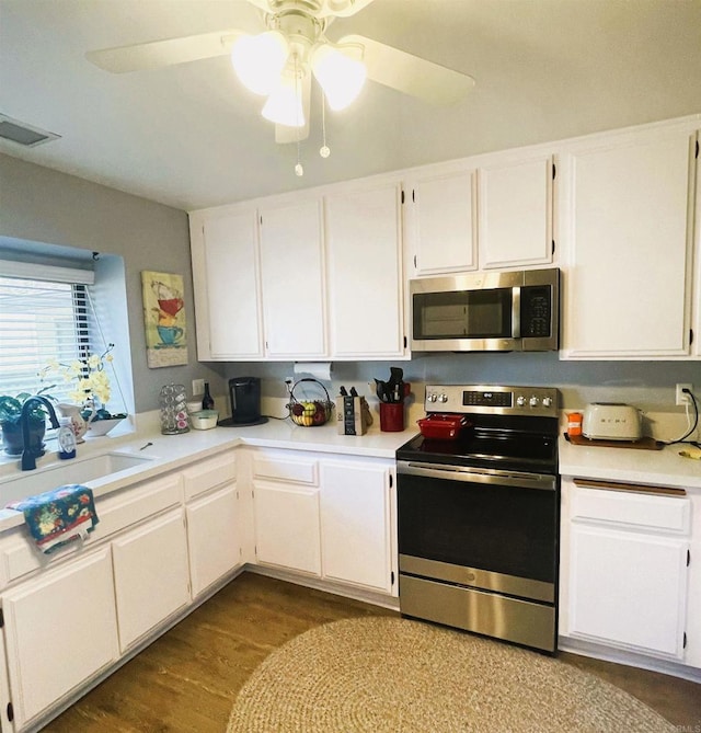 4115 Cyprus Island Ct, Fallbrook, CA 92028 - kitchen featuring appliances with stainless steel finishes, a sink, light countertops, white cabinets, and ceiling fan