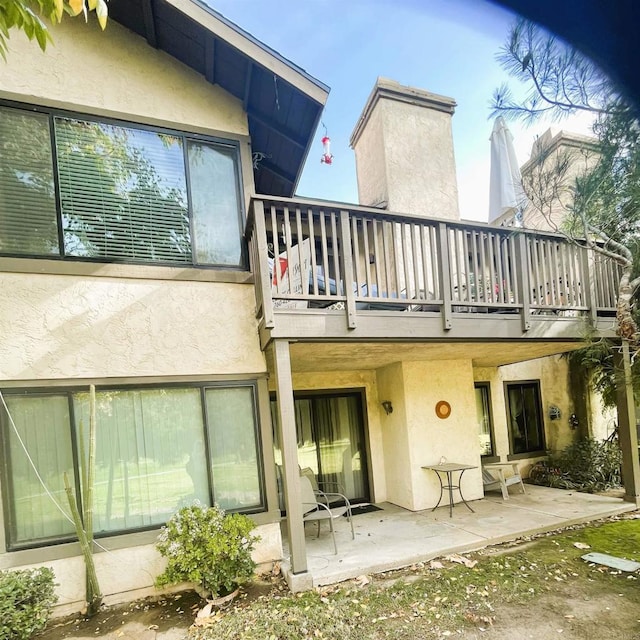 4115 Cyprus Island Ct, Fallbrook, CA 92028 - rear view of house with stucco siding, a patio area, and a balcony