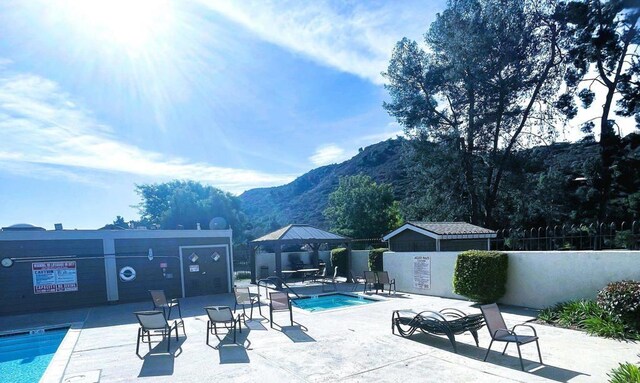 4115 Cyprus Island Ct, Fallbrook, CA 92028 - community pool featuring a gazebo, a mountain view, a community hot tub, and a patio area