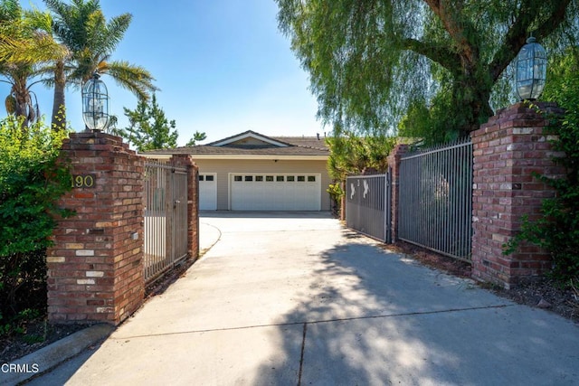 view of gate with a garage