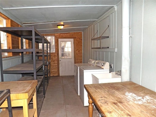 clothes washing area featuring sink and independent washer and dryer