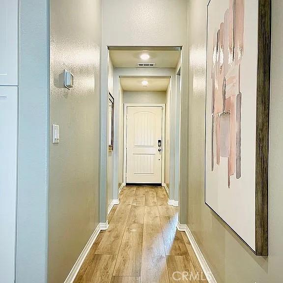 hallway with light hardwood / wood-style flooring