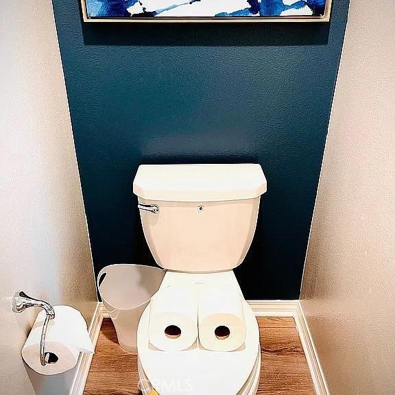 room details featuring hardwood / wood-style floors and toilet