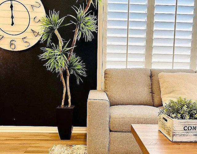 living area with hardwood / wood-style flooring