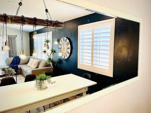 dining area featuring beam ceiling