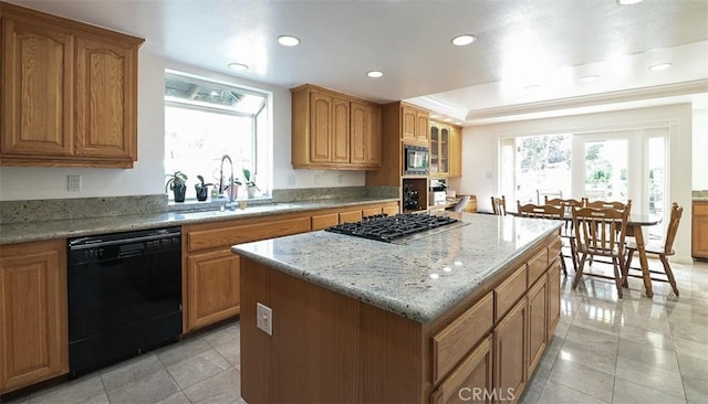 kitchen featuring stainless steel gas stovetop, dishwasher, a center island, sink, and built in microwave