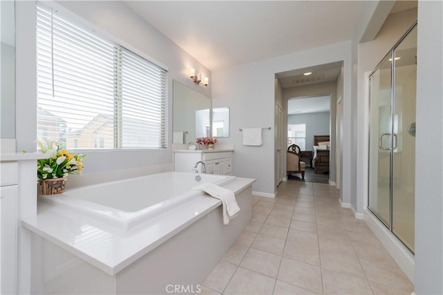 bathroom featuring vanity, tile patterned floors, and shower with separate bathtub