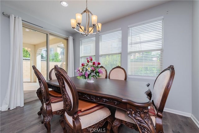 dining room with a chandelier, a healthy amount of sunlight, and dark hardwood / wood-style flooring