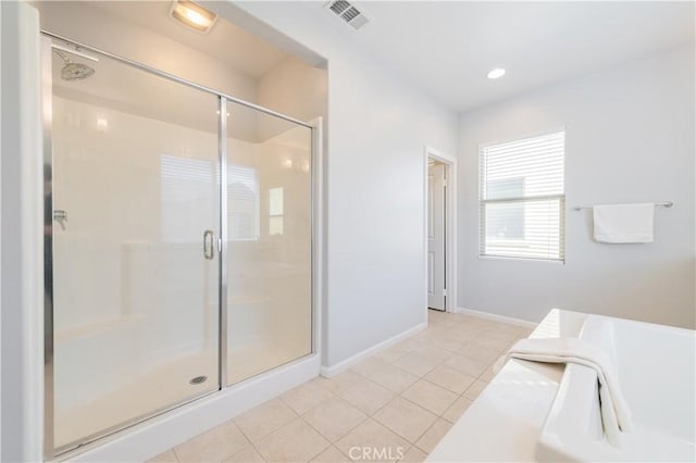 bathroom with walk in shower and tile patterned floors