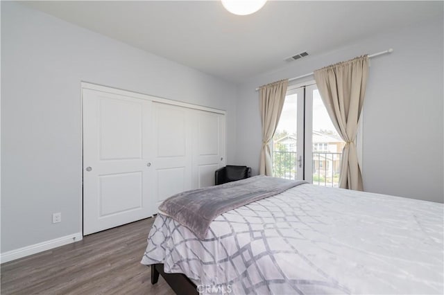 bedroom featuring wood-type flooring, a closet, and access to outside