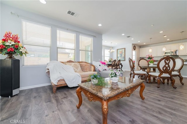 living room featuring dark wood-type flooring and a chandelier