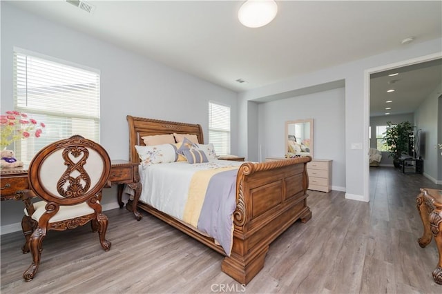 bedroom with hardwood / wood-style floors