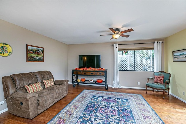 living room featuring ceiling fan and wood-type flooring