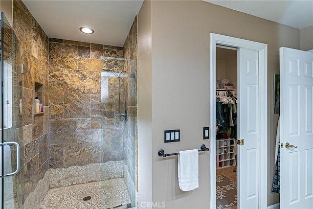 bathroom featuring a shower with door