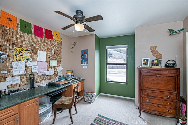 carpeted home office with ceiling fan