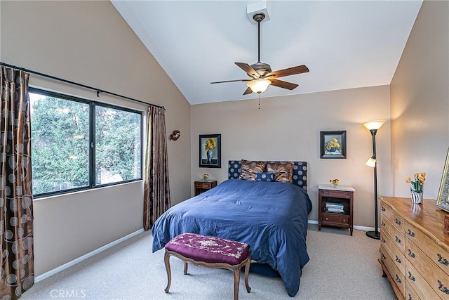 bedroom with ceiling fan, light colored carpet, and vaulted ceiling