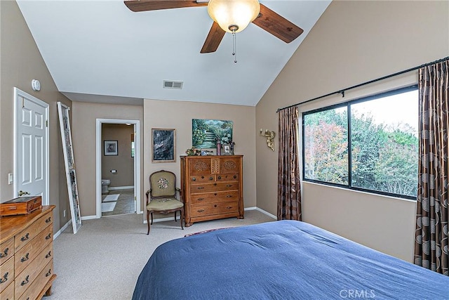 bedroom with ceiling fan, connected bathroom, lofted ceiling, and light carpet