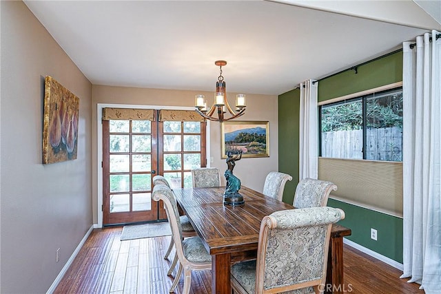 dining room with french doors, hardwood / wood-style floors, and a notable chandelier