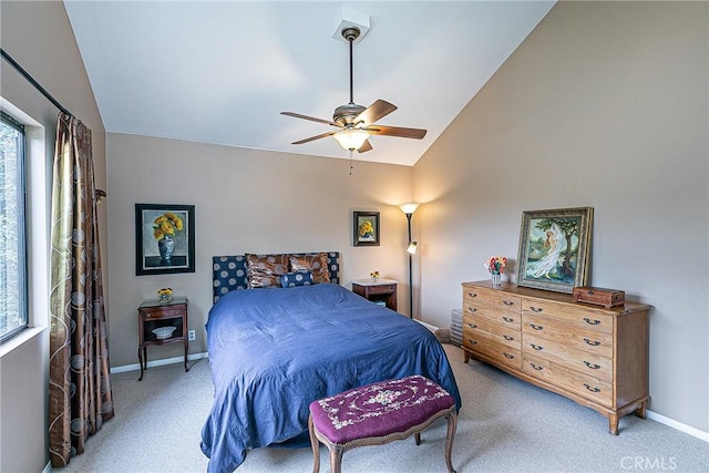 bedroom featuring ceiling fan, light colored carpet, vaulted ceiling, and multiple windows