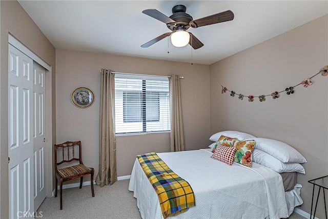 carpeted bedroom with ceiling fan and a closet