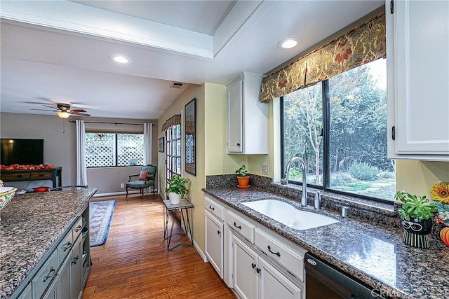 kitchen with ceiling fan, dark hardwood / wood-style floors, sink, white cabinets, and dark stone counters