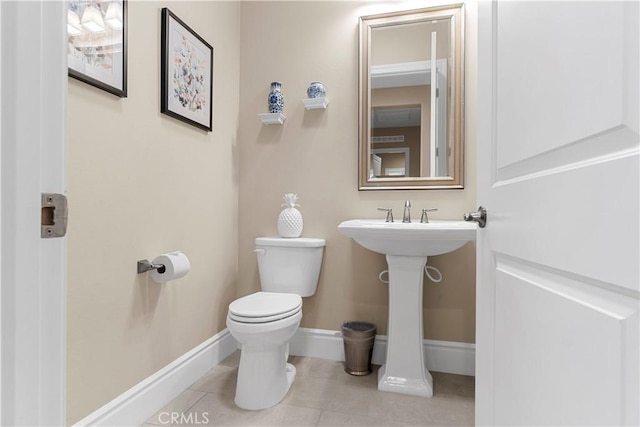 bathroom featuring sink, toilet, and tile patterned flooring