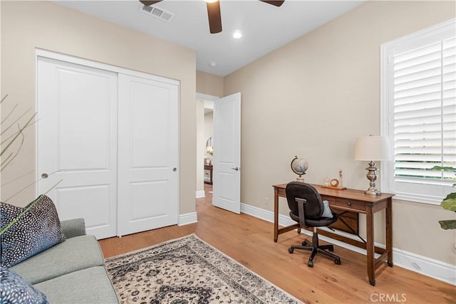 office with ceiling fan and hardwood / wood-style flooring