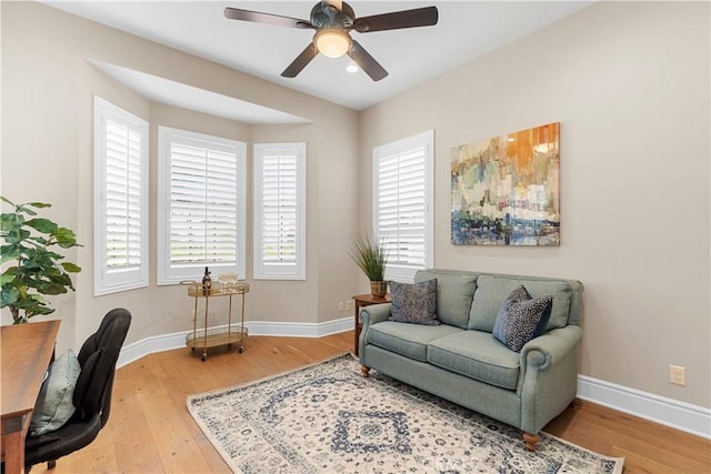 interior space with ceiling fan and wood-type flooring