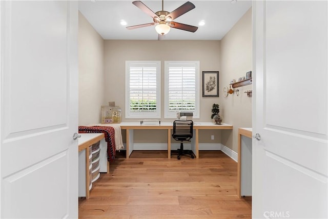 office with ceiling fan, built in desk, and light hardwood / wood-style flooring