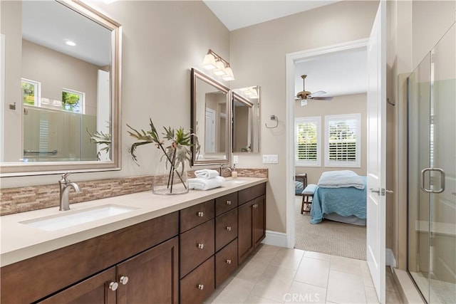 bathroom with ceiling fan, vanity, tile patterned floors, and a shower with shower door