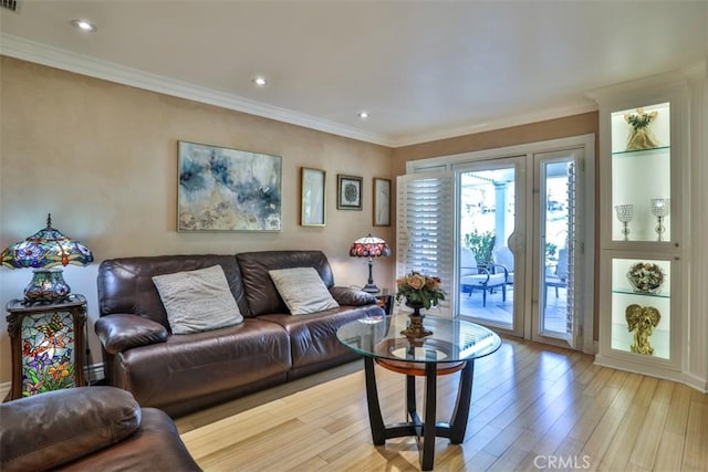 living room featuring light hardwood / wood-style floors and crown molding