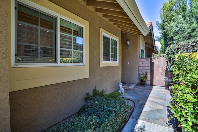 view of exterior entry with a patio area