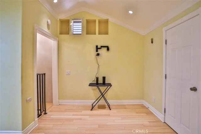 laundry room featuring crown molding and light hardwood / wood-style floors