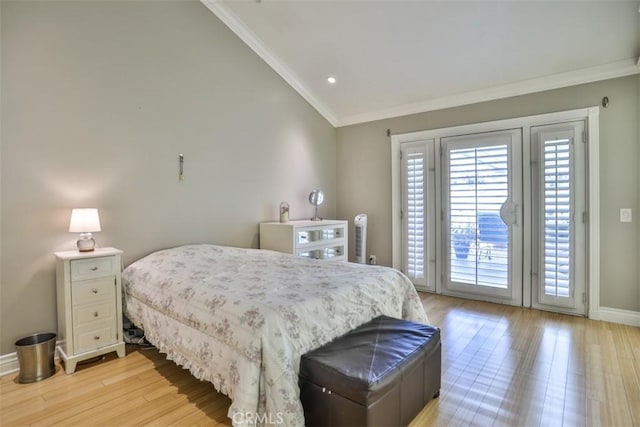 bedroom featuring vaulted ceiling, access to exterior, light hardwood / wood-style floors, and ornamental molding