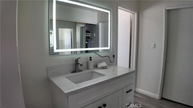 bathroom featuring wood-type flooring and vanity