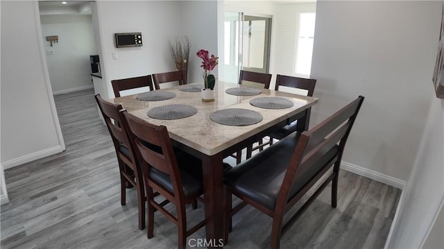 dining area with hardwood / wood-style flooring