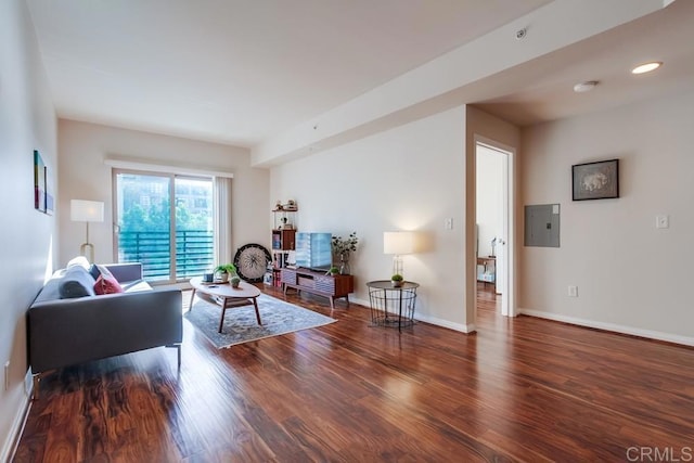 living room with dark wood-type flooring and electric panel